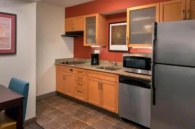 a kitchen with a refrigerator and a sink at Residence Inn Philadelphia Valley Forge in Berwyn