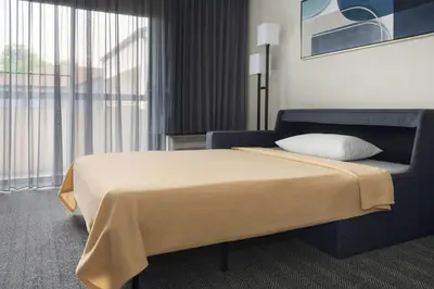 a hotel room with a bed and a large window at Courtyard Philadelphia Valley Forge / King of Prussia in Wayne