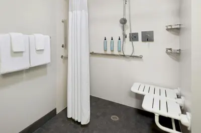 a bathroom with a white shower curtain and towels at Courtyard Philadelphia Valley Forge / King of Prussia in Wayne