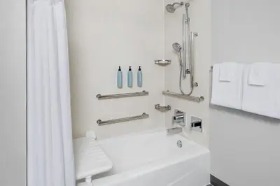 a white bathroom with a shower and a sink at Courtyard Philadelphia Valley Forge / King of Prussia in Wayne