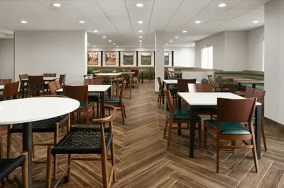 a dining room with tables and chairs at Fairfield Inn & Suites by Marriott Newark Liberty International Airport in Newark