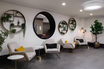 a waiting room with chairs and mirrors at Courtyard New York Manhattan/Times Square in New York