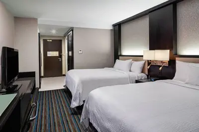 a hotel room with two beds and a flat screen tv at Courtyard New York Manhattan/Times Square in New York