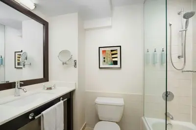 a bathroom with a toilet and a sink and a shower at Courtyard New York Manhattan/Times Square in New York