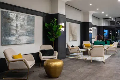 a waiting room with a bunch of chairs and tables at Courtyard New York Manhattan/Times Square in New York