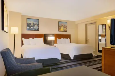 a hotel room with two beds and a chair at Residence Inn by Marriott New York Manhattan/Times Square in New York