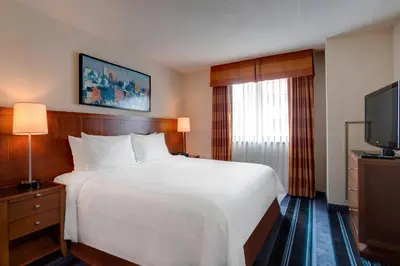 a hotel room with a bed and a flat screen tv at Residence Inn by Marriott New York Manhattan/Times Square in New York