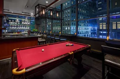 a red pool table in a bar with a city at Residence Inn by Marriott New York Manhattan/Times Square in New York