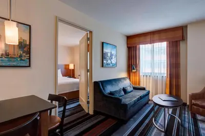 a hotel room with a couch and a bedroom at Residence Inn by Marriott New York Manhattan/Times Square in New York