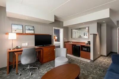 a hotel room with a desk and a television at Courtyard Philadelphia Valley Forge Collegeville in Collegeville