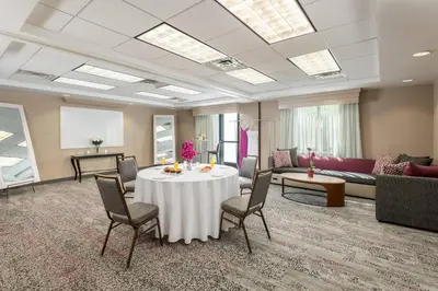 a large room with a table and chairs and a couch at Courtyard Philadelphia Valley Forge Collegeville in Collegeville