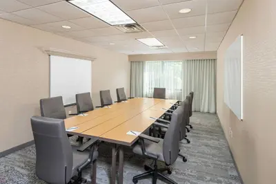 a conference room with a large wooden table and chairs at Courtyard Philadelphia Valley Forge Collegeville in Collegeville