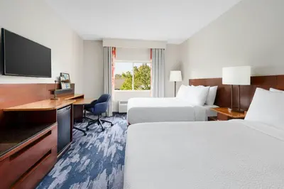a hotel room with two beds and a desk at Fairfield Inn Philadelphia Airport in Philadelphia