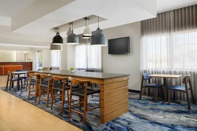 a kitchen and dining room with a large table and chairs at Fairfield Inn Philadelphia Airport in Philadelphia