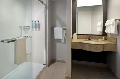 a bathroom with a sink and a shower at Courtyard by Marriott Paramus in Paramus