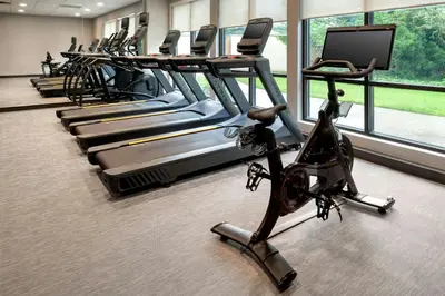 a row of exercise bikes in a gym at Courtyard by Marriott Paramus in Paramus