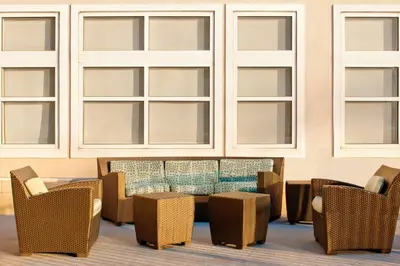 a room with a table and chairs and windows at Residence Inn by Marriott Newark Elizabeth/Liberty International Airport in Elizabeth