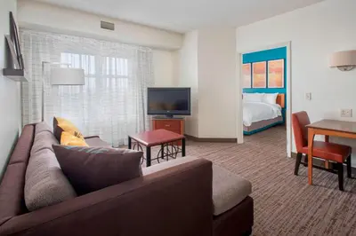 a living room with a couch and a television and a bed at Residence Inn by Marriott Newark Elizabeth/Liberty International Airport in Elizabeth