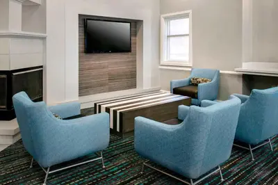 a waiting room with blue chairs and a tv at Residence Inn by Marriott Newark Elizabeth/Liberty International Airport in Elizabeth