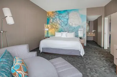 a hotel room with a bed and a couch at Courtyard by Marriott Newark Elizabeth in Elizabeth