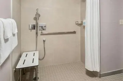 a bathroom with a shower with a shower curtain at Courtyard by Marriott Newark Elizabeth in Elizabeth