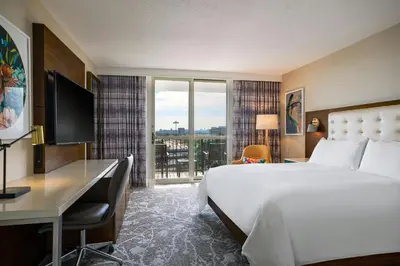 a hotel room with a bed and a desk and a window at Renaissance Meadowlands Hotel in Rutherford