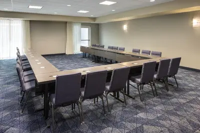 a large conference room with a long table and chairs at Courtyard Edison Woodbridge in Edison