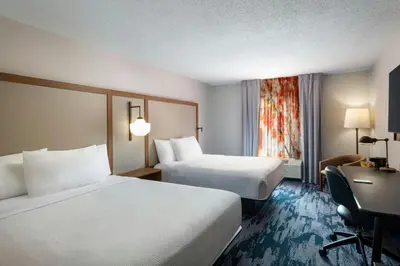 a hotel room with two beds and a desk at Fairfield Inn & Suites by Marriott Edison - South Plainfield in Edison