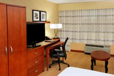 a hotel room with a desk with a television and a bed at Courtyard Rockaway-Mount Arlington in Mount Arlington