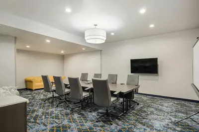 a conference room with a long table and chairs at Courtyard Rockaway-Mount Arlington in Mount Arlington