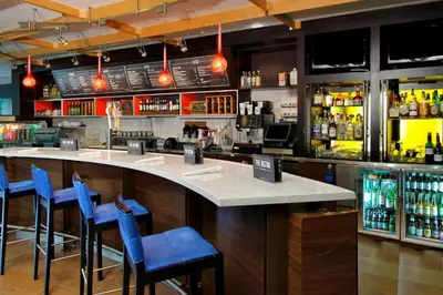 a bar with blue bar stools in a restaurant at Courtyard Rockaway-Mount Arlington in Mount Arlington