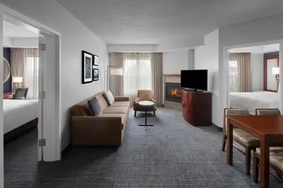 a hotel room with a couch and a fireplace at Residence Inn East Rutherford Meadowlands in East Rutherford