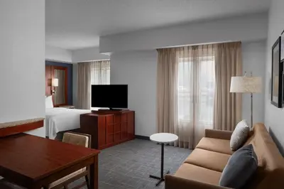 a hotel room with a couch and a bed at Residence Inn East Rutherford Meadowlands in East Rutherford