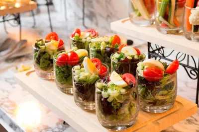 a bunch of salad dishes in glass jars on a shelf at Hanover Marriott in Whippany