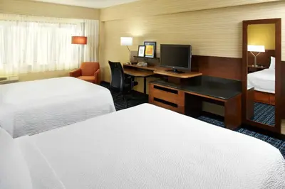 a hotel room with two beds and a desk with a computer at Fairfield Inn & Suites Parsippany in Parsippany