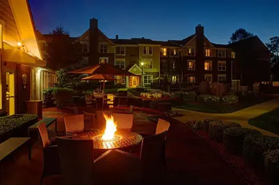 a table with a fire in the middle of a patio at Residence Inn by Marriott Saddle River in Saddle River