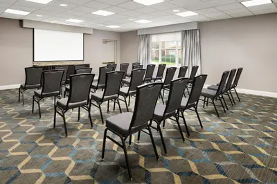 a conference room with chairs and a projection screen at Residence Inn by Marriott Saddle River in Saddle River