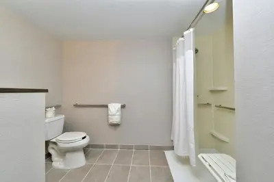 a bathroom with a toilet and a shower at Courtyard by Marriott Harrisburg Hershey in Harrisburg
