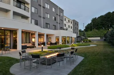 a group of chairs and tables outside of a building at Courtyard by Marriott Harrisburg Hershey in Harrisburg