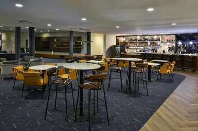 a restaurant with tables and chairs and a bar at Courtyard by Marriott Harrisburg Hershey in Harrisburg