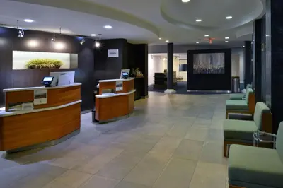 a lobby with a waiting room with desks and chairs at Courtyard by Marriott Harrisburg Hershey in Harrisburg