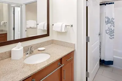a bathroom with a sink and a mirror and a shower at Residence Inn by Marriott Harrisburg Hershey in Harrisburg