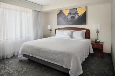a hotel room with a bed and a large window at Courtyard by Marriott Princeton in Princeton