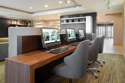an office with three computer monitors on a desk at Courtyard by Marriott Princeton in Princeton
