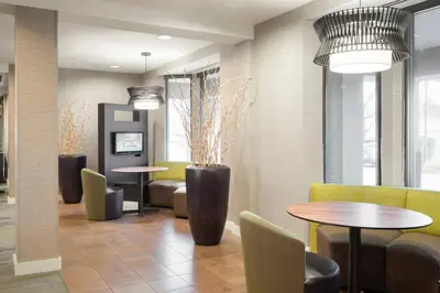 a lobby with two tables and chairs and tablesktop at Courtyard by Marriott Princeton in Princeton