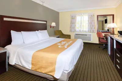 a hotel room with a large bed and a desk at Days Inn by Wyndham Nanuet / Spring Valley in Nanuet