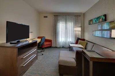 a hotel room with a television and a living room at Residence Inn by Marriott Philadelphia Valley Forge/Collegeville in Collegeville