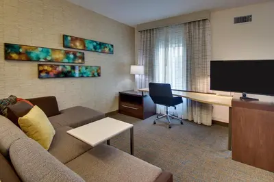 a living room with a couch and a desk in a hotel room at Residence Inn by Marriott Philadelphia Valley Forge/Collegeville in Collegeville