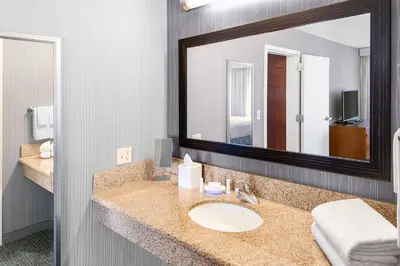 a bathroom with a sink and a large mirror at Courtyard Bethlehem Lehigh Valley/I-78 in Bethlehem