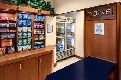 a grocery store with a refrigerator and a counter with food at Courtyard Bethlehem Lehigh Valley/I-78 in Bethlehem